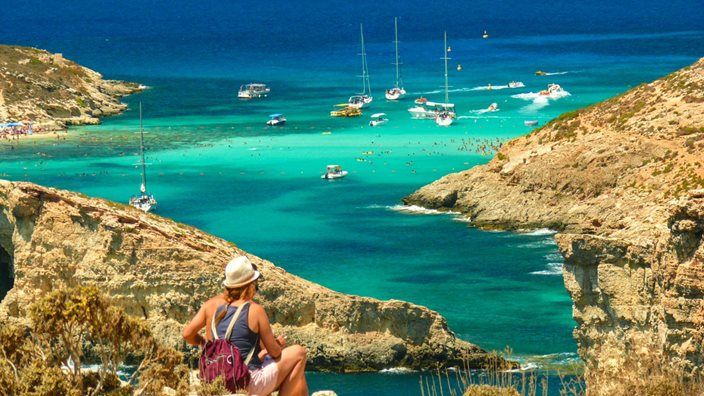 Summer view of the Blue Lagoon on Gozo, Malta – golden cliffs and turquoise sea