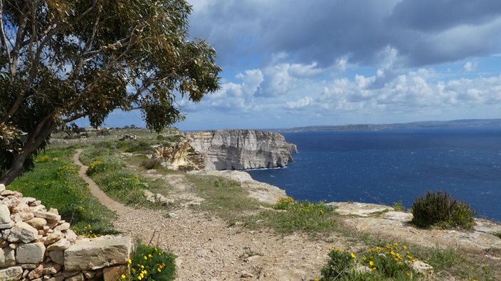 Autumn sunlight over the Ta’ Ċenċ cliffs and salt pans on Gozo, Malta