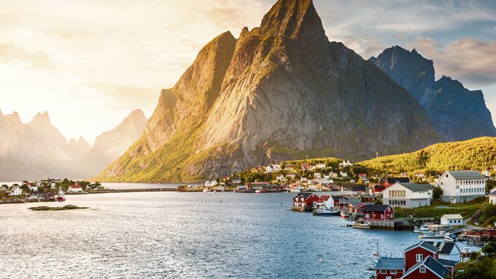Early summer landscape of Norway’s Lofoten Islands with turquoise waters and rugged peaks