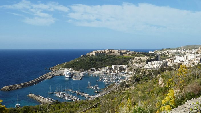 View of Gozo, Malta’s lush winter landscape with coastal cliffs and farmland